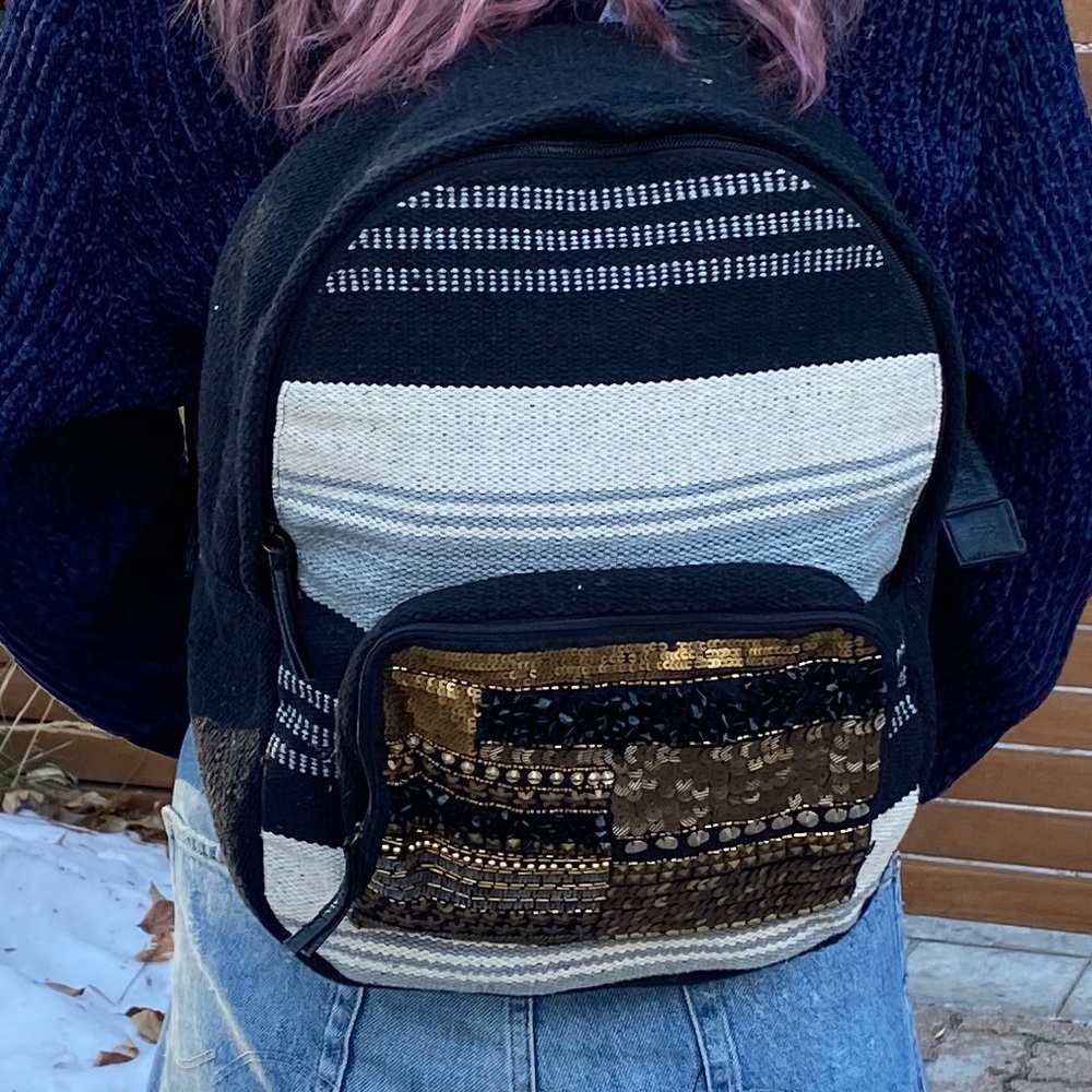Fabric backpack with a bedazzled front pocket